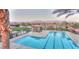 Sparkling community pool with lap lanes, shaded seating areas, and meticulously maintained landscaping at 7404 Eggshell Dr, North Las Vegas, NV 89084
