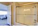 Bathroom featuring a glass-enclosed shower with bench, and bright lighting at 745 N Royal Crest Cir # 127, Las Vegas, NV 89169