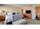 Bright bedroom with carpet, a queen bed, and dresser with TV at 745 N Royal Crest Cir # 127, Las Vegas, NV 89169