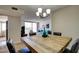 Open concept dining room showcasing a modern chandelier, seating for four, and view to living room at 745 N Royal Crest Cir # 127, Las Vegas, NV 89169