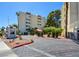 Driveway to the condo buildings with palm trees and greenery at 745 N Royal Crest Cir # 127, Las Vegas, NV 89169