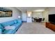 Comfortable living room with a wet bar, a view to the dining room and a stylish blue sofa at 745 N Royal Crest Cir # 127, Las Vegas, NV 89169