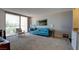 Open concept living room with a bright blue couch and view to the balcony at 745 N Royal Crest Cir # 127, Las Vegas, NV 89169