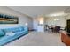 Bright living room with a stylish blue sofa, painting, wet bar and view to the dining room at 745 N Royal Crest Cir # 127, Las Vegas, NV 89169