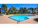 Community swimming pool with clear blue water and lounge chairs at 745 N Royal Crest Cir # 127, Las Vegas, NV 89169
