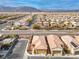 Expansive aerial view of a residential neighborhood, showcasing houses with desert landscaping and mountain views at 7611 Redcloud Peak St St, Las Vegas, NV 89166