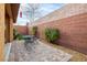 Charming back patio area with brick pavers, seating, a brick wall, and string lights, perfect for outdoor entertaining at 7611 Redcloud Peak St St, Las Vegas, NV 89166