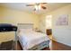 Bedroom boasts hardwood floors, a ceiling fan, and access to an ensuite bathroom at 7611 Redcloud Peak St St, Las Vegas, NV 89166