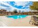 Community swimming pool with lounge chairs and covered seating, ideal for enjoying sunny days at 7611 Redcloud Peak St St, Las Vegas, NV 89166