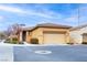 Single-story home with two-car garage, desert landscaping, and neighborhood street at 7611 Redcloud Peak St St, Las Vegas, NV 89166