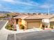 Well-manicured front yard featuring desert landscaping, a two car garage, and a covered entryway at 7611 Redcloud Peak St St, Las Vegas, NV 89166