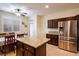 Eat-in kitchen with granite counters, stainless steel appliances, and dark wood cabinets at 7611 Redcloud Peak St St, Las Vegas, NV 89166