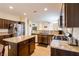 Bright kitchen with stainless steel appliances, granite counters, and dark wood cabinets at 7611 Redcloud Peak St St, Las Vegas, NV 89166