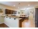 Spacious kitchen with granite countertops, dark wood cabinets, and breakfast bar at 7611 Redcloud Peak St St, Las Vegas, NV 89166