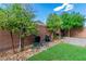Private backyard featuring a mix of lush greenery, a paved patio, and a well-maintained fence at 7624 Mallard Bay Ave, Las Vegas, NV 89179