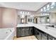 Large bathroom features dual sinks, large mirror and a soaking tub at 7624 Mallard Bay Ave, Las Vegas, NV 89179