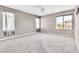 This carpeted bedroom has large windows that provide natural light at 7624 Mallard Bay Ave, Las Vegas, NV 89179