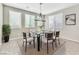 Bright dining room featuring a glass table, modern chandelier, and lots of natural light at 7624 Mallard Bay Ave, Las Vegas, NV 89179