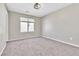 Neutral colored room featuring carpeted floors, a bright window, and fresh paint ready for customization at 7624 Mallard Bay Ave, Las Vegas, NV 89179
