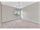 Spacious empty room with plush carpeting, a large window, and fresh paint ready for customization at 7624 Mallard Bay Ave, Las Vegas, NV 89179