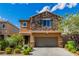 Inviting two-story home with a stone facade and manicured landscaping, plus an attached garage at 7624 Mallard Bay Ave, Las Vegas, NV 89179