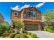 This two-story home has a stone facade and a large driveway at 7624 Mallard Bay Ave, Las Vegas, NV 89179