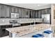 Modern kitchen featuring stainless steel appliances, granite counters, and sleek dark cabinetry at 7624 Mallard Bay Ave, Las Vegas, NV 89179