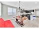 Open concept kitchen with stone countertops, stainless steel appliances, and views into the dining area at 7624 Mallard Bay Ave, Las Vegas, NV 89179