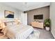 Stylishly staged bedroom with neutral tones, modern lighting, and comfortable furnishings at 7624 Mallard Bay Ave, Las Vegas, NV 89179