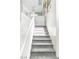 Carpeted staircase featuring white trim and a decorative railing at 7624 Mallard Bay Ave, Las Vegas, NV 89179