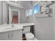 Bright bathroom with a well-lit vanity, modern sink and toilet, and an architectural display shelf at 8012 Desire Ave, Las Vegas, NV 89128