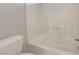 Clean, bright bathroom with a white tile shower, tub and a modern toilet, ensuring a relaxing experience at 8012 Desire Ave, Las Vegas, NV 89128