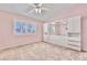 Bedroom features a window with shutters, fan, and built-in shelving and drawers at 8012 Desire Ave, Las Vegas, NV 89128