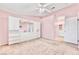 Large bedroom shows a spacious layout, carpet, and access to the bathroom and closet at 8012 Desire Ave, Las Vegas, NV 89128