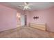 Bedroom with pastel walls, neutral carpeting, modern ceiling fan and contemporary dresser at 8012 Desire Ave, Las Vegas, NV 89128
