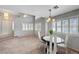 Inviting dining area with plantation shutters, high ceilings, and views of the entry and adjacent living space at 8012 Desire Ave, Las Vegas, NV 89128
