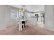 Bright dining area features a round table, white chairs, and is open to the kitchen with white cabinetry at 8012 Desire Ave, Las Vegas, NV 89128