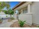 Inviting covered front porch with a gated entrance and desert landscaping at 8012 Desire Ave, Las Vegas, NV 89128
