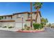 Charming townhome featuring a stucco exterior, red tile roof, two-car garage, and desert landscaping at 8012 Desire Ave, Las Vegas, NV 89128