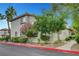Charming condo exterior with mature landscaping, palm trees, and well-maintained grounds at 8012 Desire Ave, Las Vegas, NV 89128