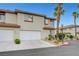 Well-maintained townhome with a two-car garage, desert landscaping, and a stucco exterior at 8012 Desire Ave, Las Vegas, NV 89128