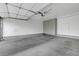 Spacious garage with finished walls, flooring, storage cabinets, and an electric door for convenience at 8012 Desire Ave, Las Vegas, NV 89128