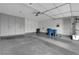 Spacious garage with ample storage cabinets, epoxy flooring and a water heater at 8012 Desire Ave, Las Vegas, NV 89128