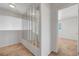 Bright hallway with modern mirrors leading to bedrooms with neutral carpeting at 8012 Desire Ave, Las Vegas, NV 89128