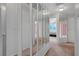 Hallway with decorative mirrors, neutral carpeting, and natural light at 8012 Desire Ave, Las Vegas, NV 89128