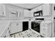 This kitchen features black appliances, white cabinetry, and patterned flooring at 8012 Desire Ave, Las Vegas, NV 89128