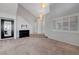 Spacious living room featuring vaulted ceilings, neutral carpet, and a fireplace at 8012 Desire Ave, Las Vegas, NV 89128
