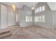 Spacious living room featuring high ceilings, carpet flooring, and large windows with shutters at 8012 Desire Ave, Las Vegas, NV 89128