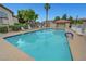 Sparkling community pool with sun loungers and a covered cabana for relaxing poolside at 8012 Desire Ave, Las Vegas, NV 89128