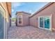 A view of the home's private back patio featuring brick pavers and access to the house at 8212 Cabin Springs Ave, Las Vegas, NV 89131